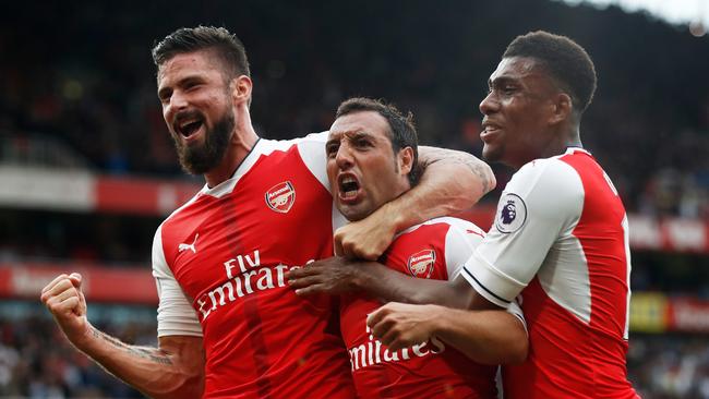 Santi Cazorla of Arsenal (C) celebrates scoring.