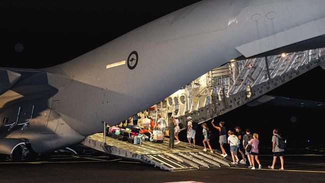 Australian citizens boarding a Royal Australian Air Force C-17A transport aircraft at Bauerfield International Airport in Port Vila, for a repatriation flight following the Vanuatu earthquake.