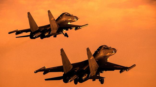 Modern Chinese long-range fighters take off into the sunset. Modern aircraft such as these give Beijing the ability to dominate the air over the South China Sea.