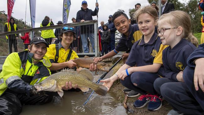 Will Ingram and Mitch Turner from the Victorian Fishing Authority with Upper Ferntree Gully Primary School students Jone, Amalia and Zoe. Picture: Andy Brownbill