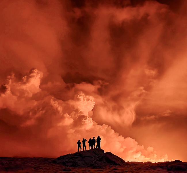 Local Icelandic residents watch the smoke billow from the eruption. Picture: Kristin Elisabet Gunnarsdottir/AFP