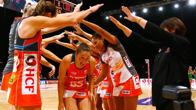 Giants shooter Susan Pettitt, who is retiring at the end of the season, runs under a guard of honour after the match. Picture: AAP