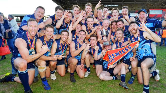 Coach John Cunningham (far right) celebrates winning the division three flag with his Glenunga side in September. Picture: AAP/Mark Brake