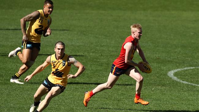 West Adelaide’s John Noble bursts through the middle of Optus Stadium in South Australia’s win against Western Australia on Sunday. Picture: Paul Kane/Getty Images