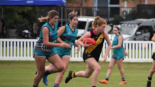 Grafton's Hanna Tait speeds away from her Coffs Breakers opponents. Photo: Green Shoots Marketing