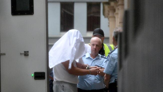 Lin covered his face as he entered court last month. Picture: NewsWire / Andrew Henshaw