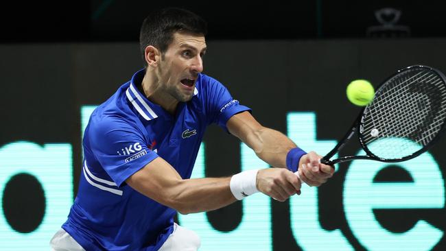 Novak Djokovic of Serbia plays a backhand to Marin Cilic