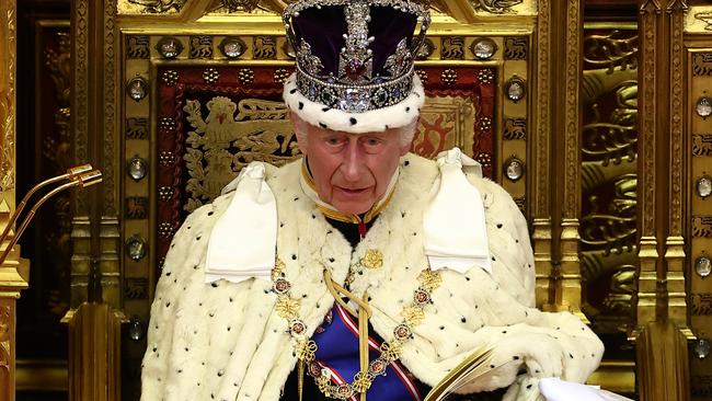LONDON, ENGLAND - JULY 17: King Charles III, wearing the Imperial State Crown and the Robe of State, reads the King's Speech from the The Sovereign's Throne in the House of Lords chamber, during the State Opening of Parliament, at the Houses of Parliament, on July 17, 2024 in London, England. King Charles III delivers the King's Speech setting out the new Labour government's policies and proposed legislation for the coming parliamentary session. (Photo by Henry Nicholls  - WPA Pool/Getty Images)
