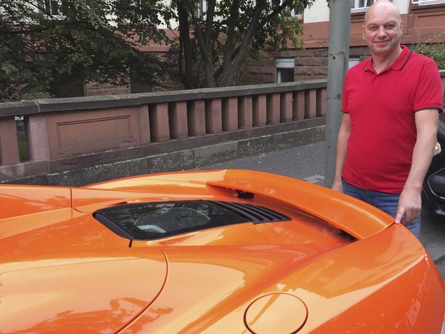 Markus Zahn stands with his sportscar in Giessen, Germany. He wanted the owner of a donkey to pony up for an alleged 5,000 euro ($A8699) in damage caused when the animal chomped the backside of the vehicle. Picture: Carolin Eckenfels/dpa via AP