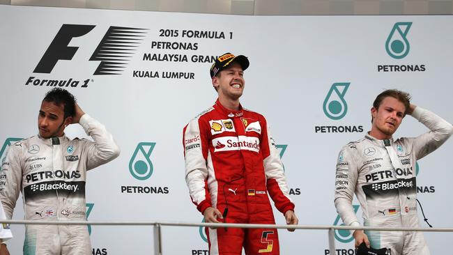 Lewis Hamilton, Sebastian Vettel, Nico Rosberg on the podium of the Malaysian Formula One Grand Prix.