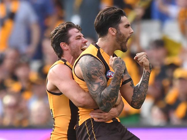 Isaac Smith (left) and Chad Wingard of the Hawks react after Wingard kicked a goal during the Round 3 AFL match between the Hawthorn Hawks and North Melbourne Kangaroos at the MCG in Melbourne, Sunday, April 7, 2019. (AAP Image/Julian Smith) NO ARCHIVING, EDITORIAL USE ONLY