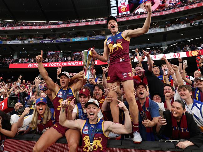 Lachie Neale, Cam Rayner and Logan Morris celebrate with the fans. Picture: Cameron Spencer/AFL Photos