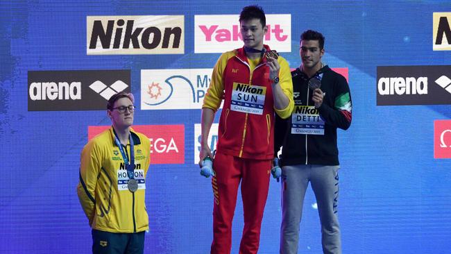 Silver medallist Australia's Mack Horton (L) refuses to stand on the podium with gold medallist China's Sun Yang (C) and bronze medallist Italy's Gabriele Detti after the final of the men's 400m freestyle event during the swimming competition at the 2019 World Championships at Nambu University Municipal Aquatics Center in Gwangju, South Korea, on July 21, 2019. (Photo by Ed JONES / AFP)