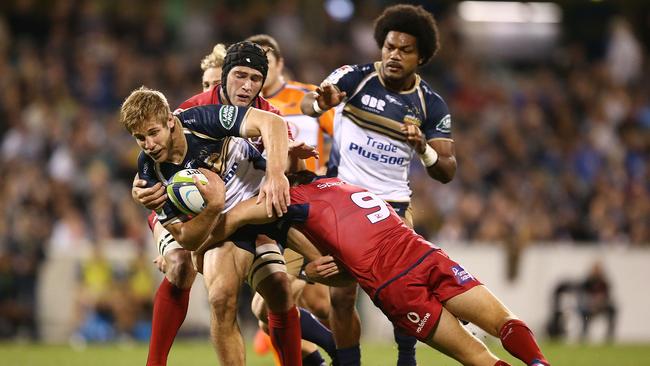 Kyle Godwin of the Brumbies is tackled at GIO Stadium.
