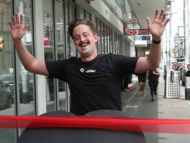 Coles Victorian City Regional Manager Ben Reeve reaches the finish line of his Coles Movember Marathon arriving at the Collingwood Coles on Smith Street on Friday, November 26, 2021, in Collingwood, Victoria, Australia. Picture: Hamish Blair