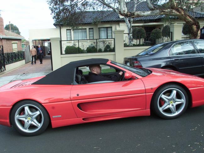 Mokbel’s red Ferrari being seized by police during a raid in August 2001.