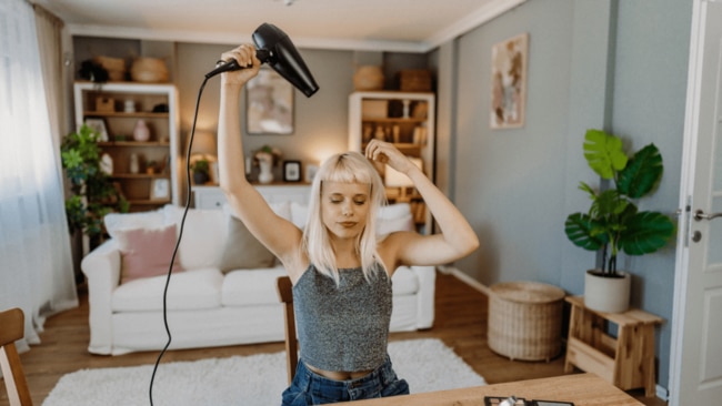 Some hair dryers have noise reduction features, but the experts recommend trying to break up your regular 10 or so minutes spent drying your lengths. Image: iStock