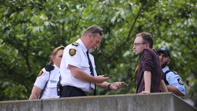 Security detains journalist Michael Koziol.