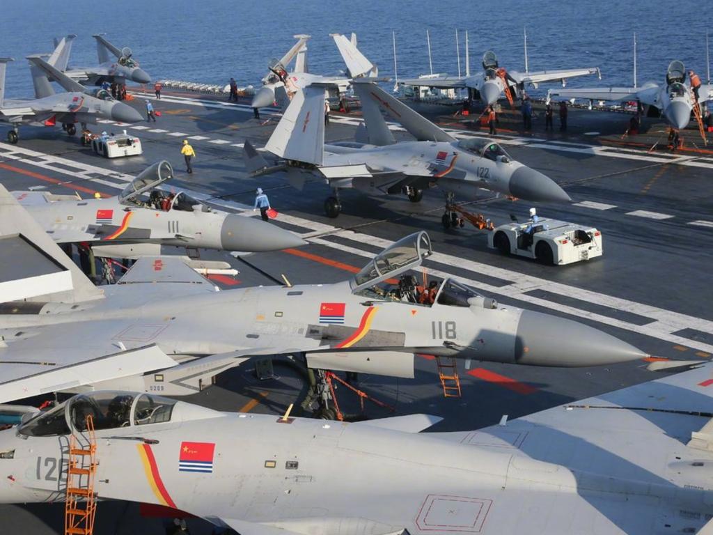 Fighter jets crowd the deck of the aircraft carrier, Liaoning. China's first home-built design is based on this Soviet-built ship. Picture: Xinhua