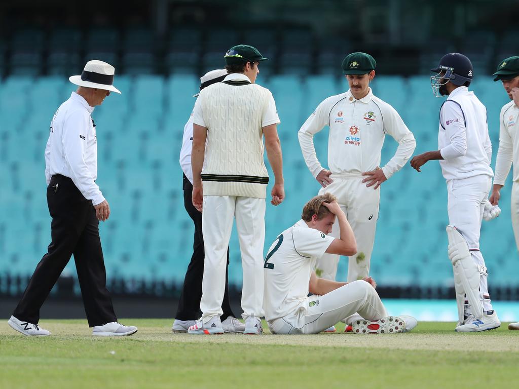 Cameron Green of Australia A reacts after being hit in the head from a shot by Jasprit Bumrah of India.