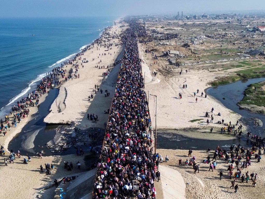 Displaced Gazans walking toward Gaza City on January 27 after crossing the Netzarim corridor from the southern Gaza Strip. Picture: AFP