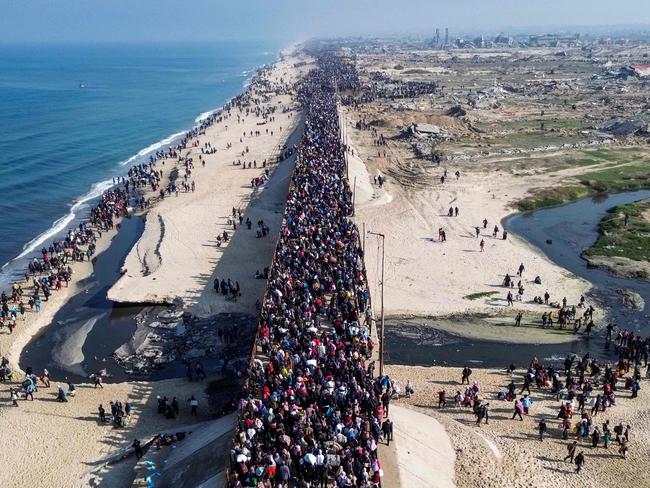 Displaced Gazans walking toward Gaza City on January 27 after crossing the Netzarim corridor from the southern Gaza Strip. Picture: AFP