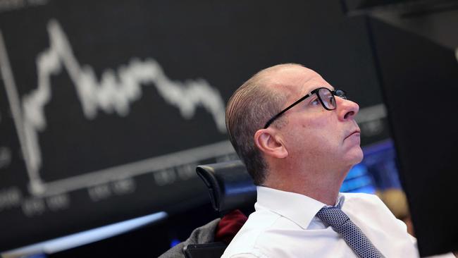 A trader at the Frankfurt stock exchange assesses movement on Germany’s DAX index. Picture: AFP