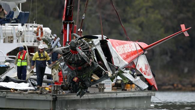 The horrific wreckage of the seaplane is removed from the water. Picture: Richard Dobson.