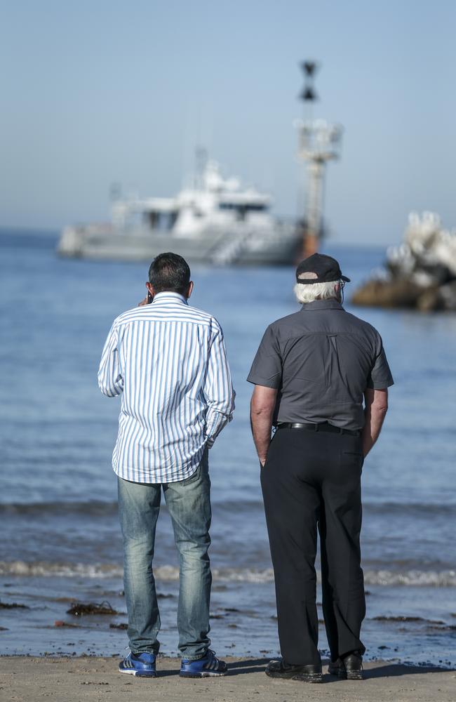 Indian Pacific School Games spokesman Surender Chahal, left, at the Glenelg breakwater where the body of Nitisha Negi was retrieved on Monday. Picture: AAP / Mike Burton