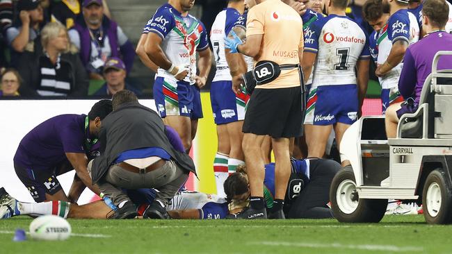 Dallin Watene-Zelezniak lays on the field before being stretchered off. Photo by Daniel Pockett/Getty Images.