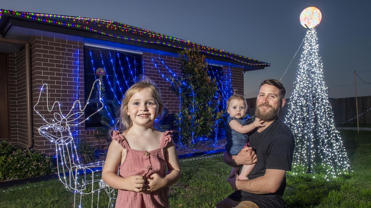 (from left) Ivy, Remi and Aiden Ferguson outside their home's Christmas display in Milford St Westbrook. Friday, December 3, 2021. Picture: Nev Madsen.