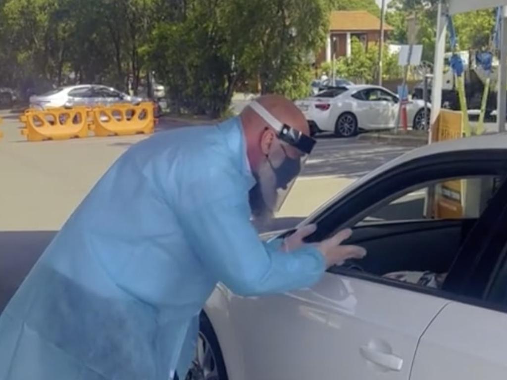 Mr Ykmour spent his day under the hot sun dressed in full PPE gear handing out tests to cars lining up at clinics.