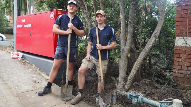 21-year-old fourth year apprentice plumber (journeyman) Tom Jacobsen and 23-year-old tradesmen Jack Brooks dig up pipes to fix a water leak in Cammeray, Sydney. Picture: Joseph Lam