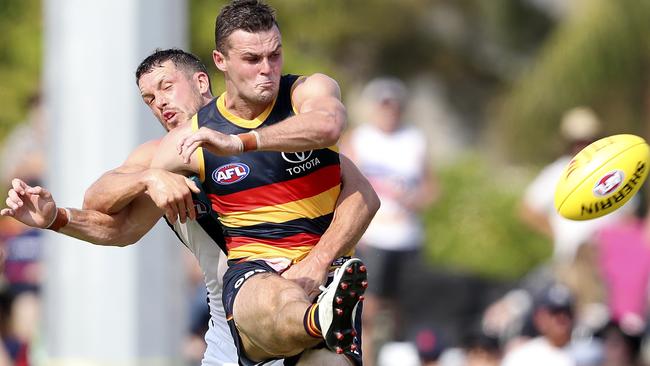 Brad Crouch kicks under pressure from Travis Boak. Picture: Sarah Reed