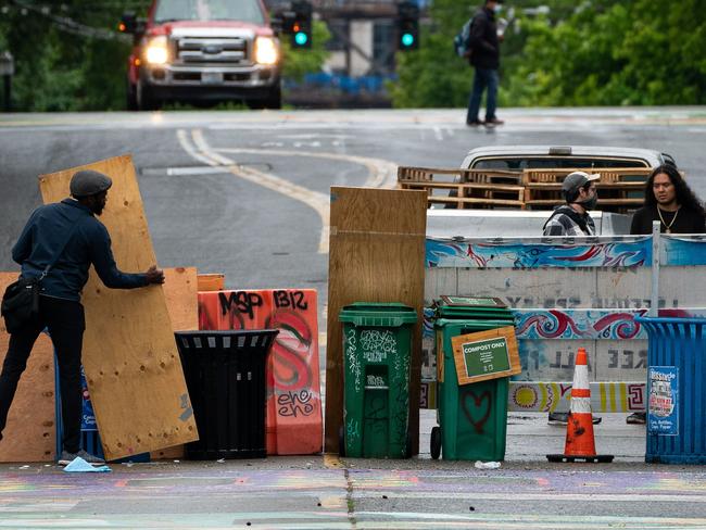 A protester adjusts a makeshift barrier in Seattle’s cop-free CHOP zone. Picture: AFP