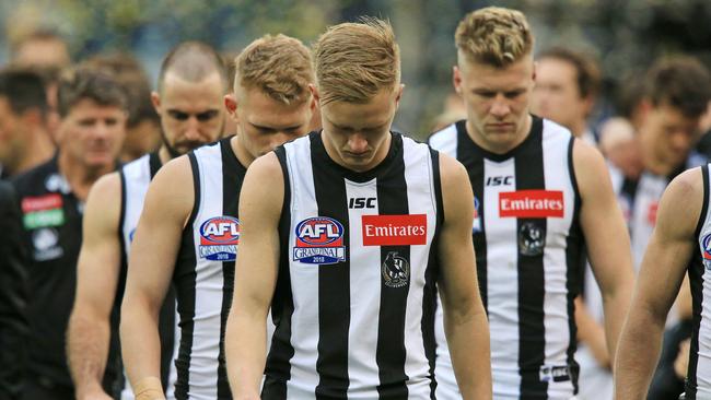 A dejected Collingwood side leaves the field. Picture: Mark Stewart