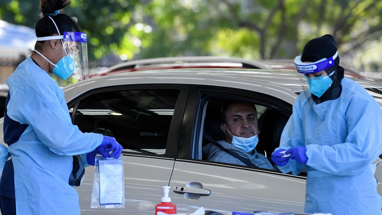 Patients wearing face masks wait to receive a Covid-19 test at the Fairfield Showground Sypath 24/7 Drive-through Clinic, in Sydney.