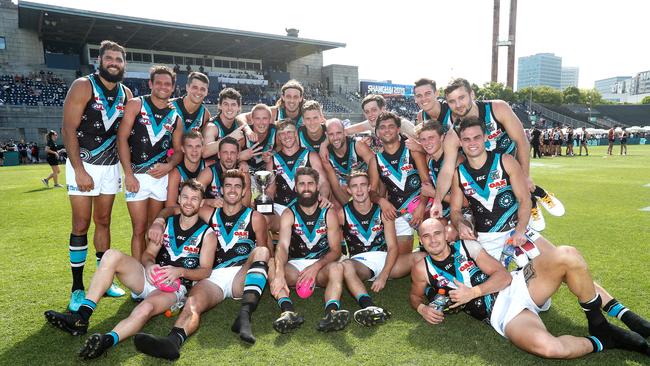 Power players celebrate with the Kennedy Cup after beating St Kilda in Shanghai. Picture: Michael Willson/AFL Photos