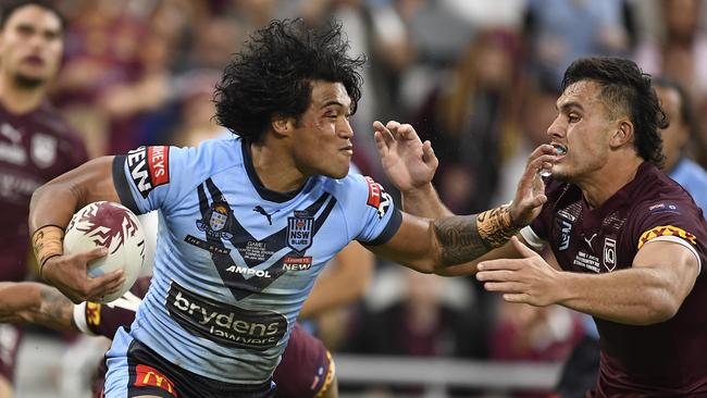 Brian To’o looks to fend off Tino Fa’asuamaleaui during Origin I. Picture: Ian Hitchcock/Getty Images