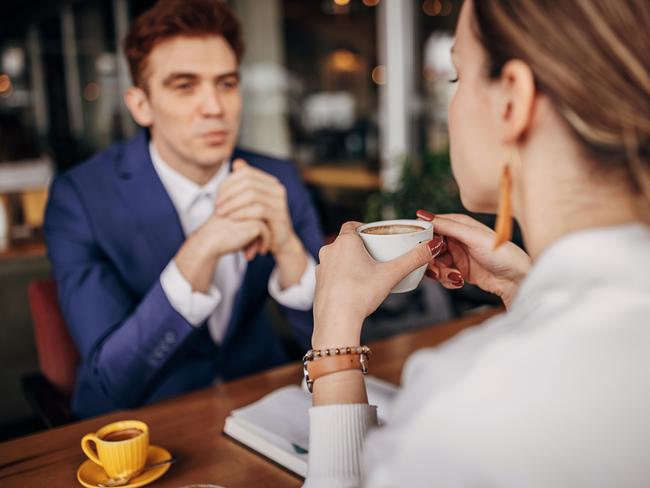 Handsome young businessman sitting on coffee with a beautiful woman in cafe.