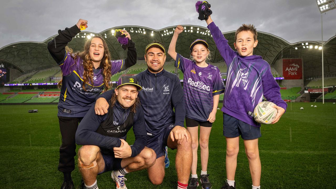 Storm stars Ryan Papenhuyzen and Jahrome Hughes meet fans Olivia, 12, Isabella, 11, and Aidan, 9, at open training ahead of the club’s qualifying final in Melbourne. Picture: Mark Stewart