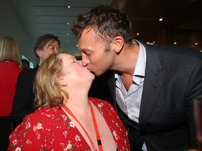 Magda Szubanski and Ian Thorpe share a kiss after the Same Sex Marriage Bill passes in the House of Representatives Chamber, at Parliament House in Canberra.