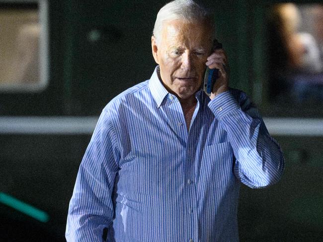 US President Joe Biden speaks on the phone while walking from Marine One to board Air Force One before departing McGuire Air Force Base in New Jersey on June 29, 2024. Biden is heading to the Camp David presidential retreat where he was expected to spend the rest of the weekend. (Photo by Mandel NGAN / AFP)