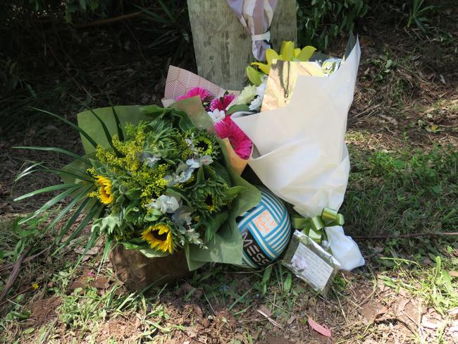 Floral tributes, cards and a soccer ball have been left on the power pole where young Archie King, 12, was killed on fagans Rd, Lisarow. Picture: Richard Noone