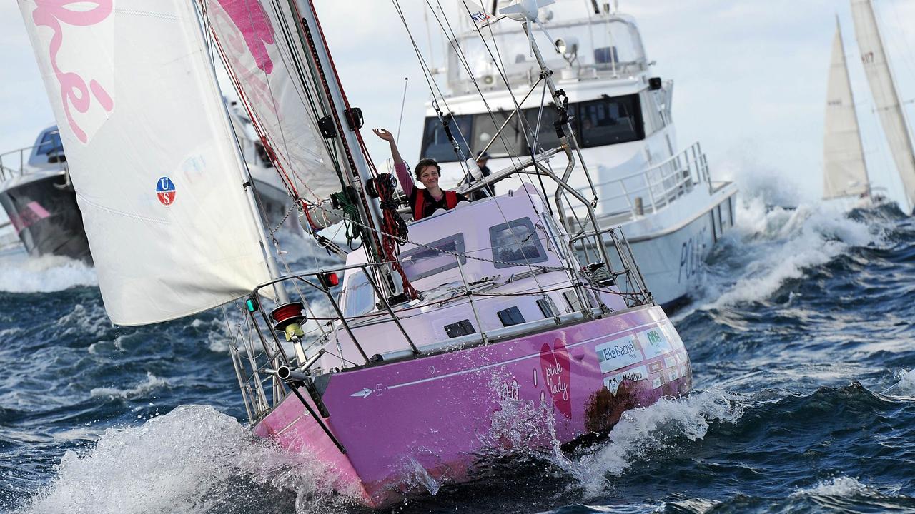 Jessica Watson waves to wellwishers as her yacht 'Ella's Pink Lady' crosses the official finish line at the entrance to Sydney Harbour in 2010. Picture: Torsten Blackwood.