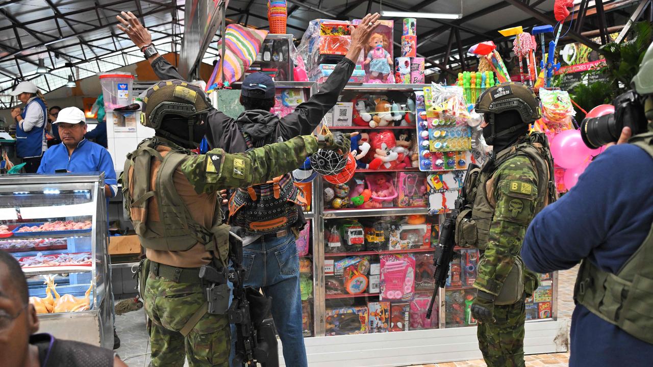 Soldiers frisk a man at a market in the neighbourhood of Moran in north Quito this week. Picture: AFP