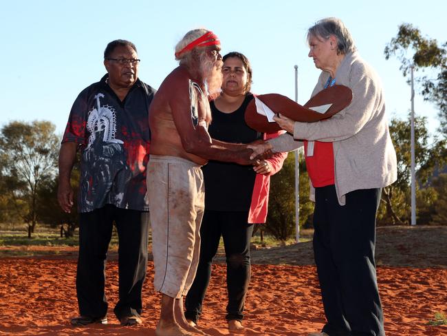 26/05/2017: Left to right:  Pedro Stephen, Mutitjulu elder Rolley Mintuma , Sally Scales and Pat Anderson being presented a piti holding holding the Uluru statement, at the closing ceremony of the Indigenous Constitutional Convention held at Mutujulu.Pic by James Croucher