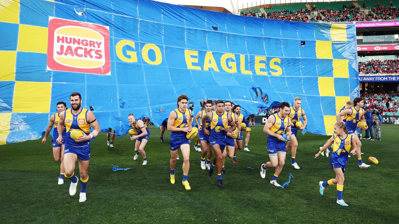 The Eagles run through their banner. Picture: Matt King/AFL Photos/via Getty Images