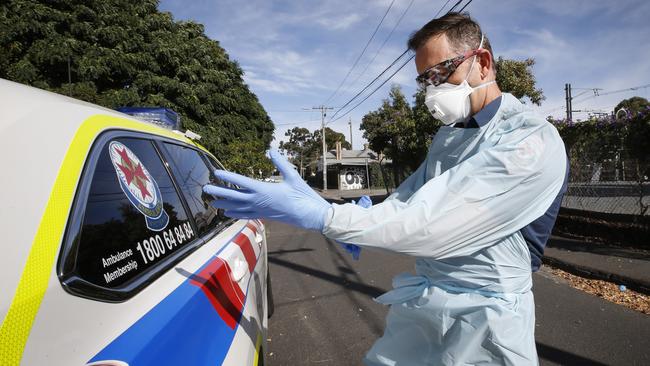 Before they =go near a patient paramedics must don their PPE. Picture: David Caird