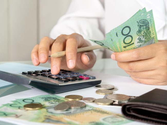 Accountant woman counting an australian money and using calculator for accounting concept. Cash savings dollars generic